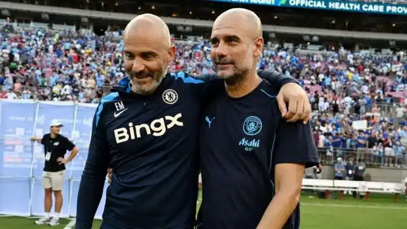 Enzo Maresca and Pep Guardiola embrace while managing opposing teams in pre-season for Chelsea and Man City