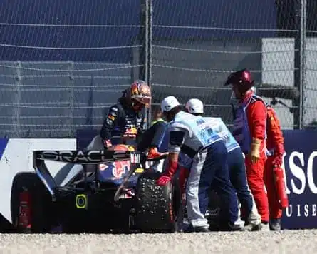 Marshals assist Max Verstappen after he crashed his Red Bull