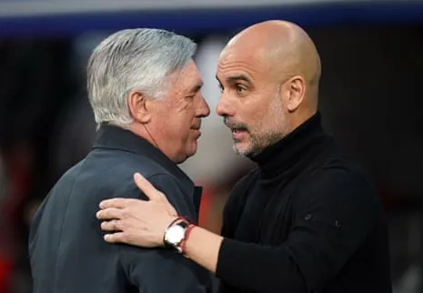 Carlo Ancelotti (left) and Pep Guardiola embrace