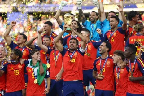 Rodri, Spain’s captain and player of the tournament, lifts the World Cup trophy alongside teammates as they celebrate winning the World Cup.
