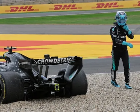 George Russell walks away from his car.