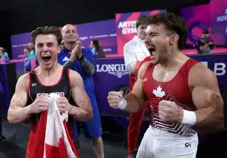 Gold medalist Felix Dolci of Canada (left) celebrates alongside his compatriate and bronze medalist William Emard after the men's horizontal bar final.