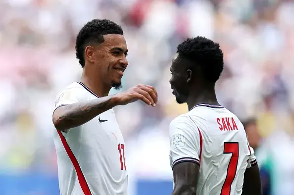 Bukayo Saka #7 of England celebrates scoring his team's fourth goal with Morgan Rogers