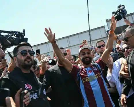 Mohamed Salah gestures as he arrives at Istanbul Ataturk Airport to complete his transfer to Turkish football club Trabzonspor
