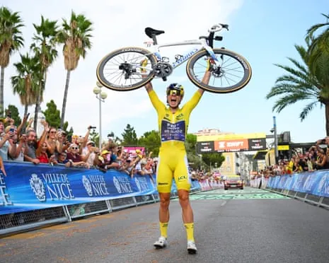 Demi Vollering lifts up her bike after winning the Tour de France Femmes